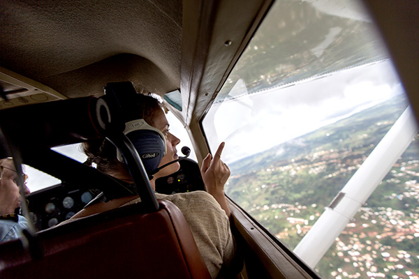 woman on a plane looking out the window